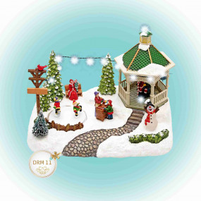 Világító karácsonyi falu, korcsolyázó gyerekekkel Világító karácsonyi falu, korcsolyázó gyerekekkel